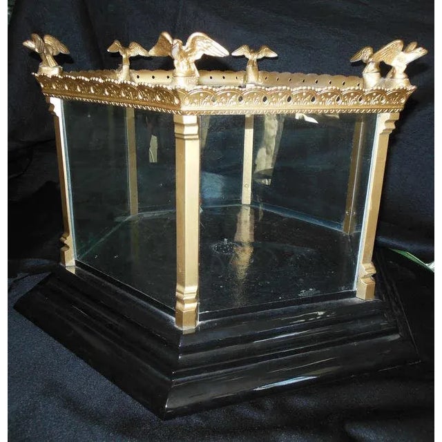 An unusual hexagonal shaped fish tank, with six flying eagles in each corner. The underneath of the tank is fitted to...