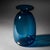 Small glass vase in an attractive petrol blue tone, featuring an elongated, rounded body, a narrow neck, and a wide lip....