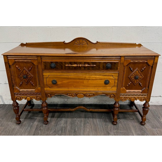 This is a beautiful vintage American Jacobean or Tudor Revival walnut buffet, sideboard, or server dating to the...
