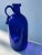 Wonderful blue bottle with profiled and polished rim. the peculiarity of the bottle is the wide handle and the serpentine...