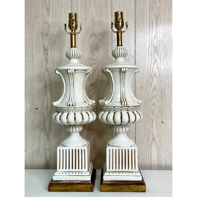 An exceptional pair of Italian glazed ceramic table lamps, beautifully crafted in the timeless Neoclassical tradition....