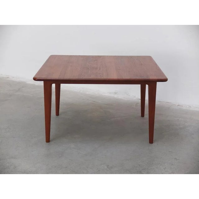 Beautiful square coffee table made out of solid teak wood with tapered legs and rounded edges. Produced by A. Mikael...