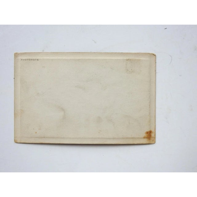 Vintage circa 1920's sepia photograph, plate marked along edges. Two Native American women and two children in a studio...