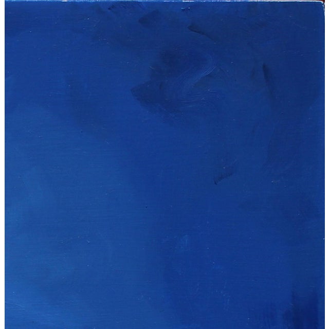 This artwork depicts two figures embracing, their bodies intertwined against a vibrant blue background. A luminous full...