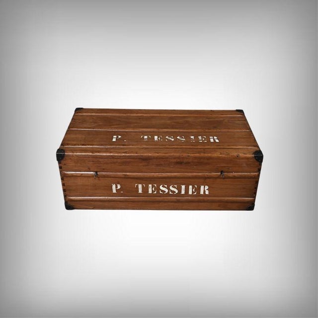 This mahogany trunk presents itself as a robust chest, its deep patina revealing a long history of travel and voyages. Its...