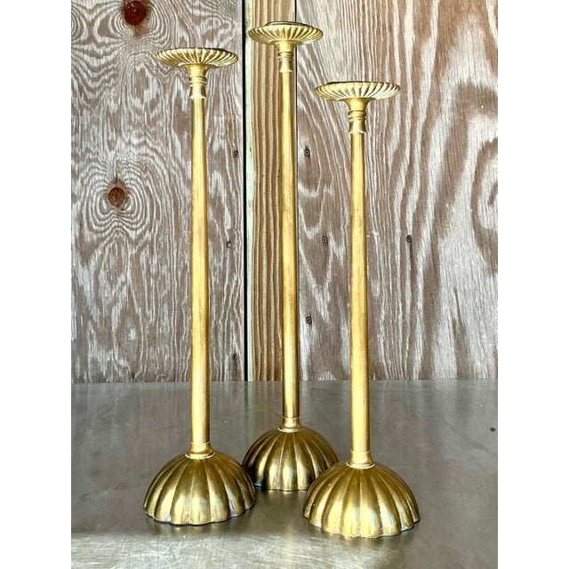 This set of three vintage boho scalloped brass candlesticks brings warmth and character to any space. Each candlestick...