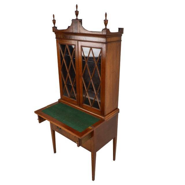 A late 19th century antique secretary desk bookcase with a classic two part form, featuring a glazed upper cabinet with...