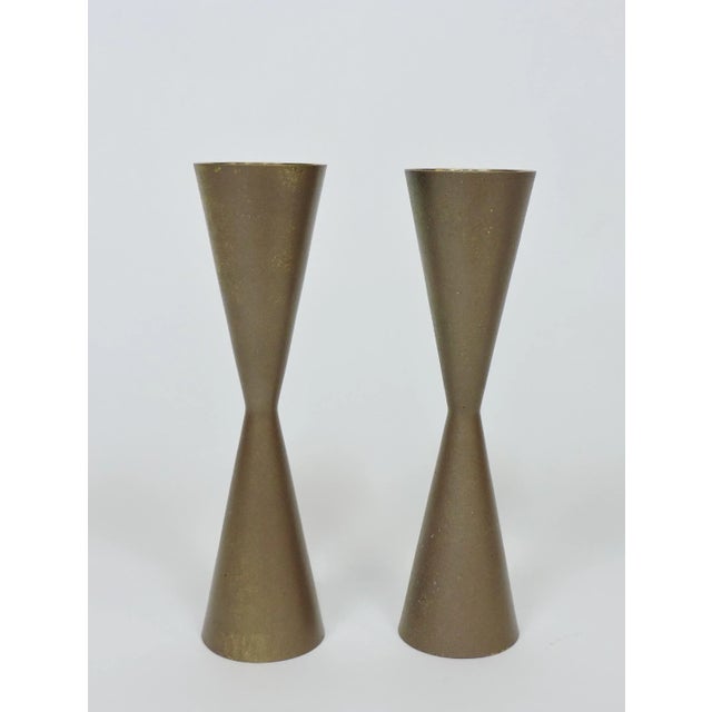 Very cool mid century candle holders in a double cone shape. These candle sticks are made of solid brass and have a...