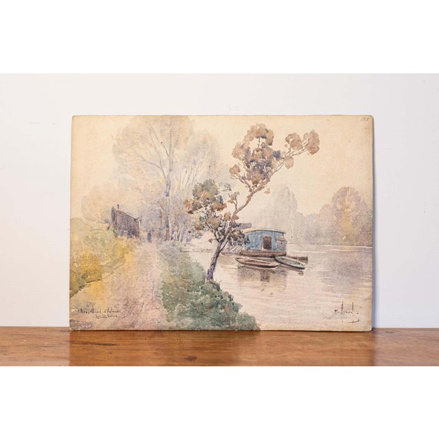 This 20th-century French watercolor captures a serene riverside scene in soft, muted tones, evoking a sense of...