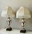 Antique French Handpainted porcelain D’ore pair of lamps . Placed on bronze bases. Custom made damask silk lamp shades...