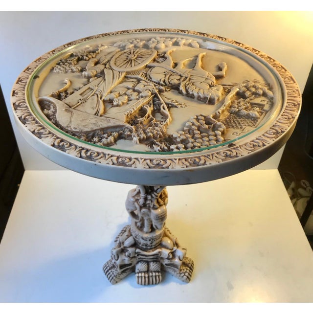 Heavy and intricately carved side, occasional or a so-called Opium Table in faux ivory. Faux ivory is heavier than regular...