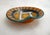 Small mid-century round dish/trinket tray with a slight fold on the rim, creating a wavy effect. Geometric/graphic...
