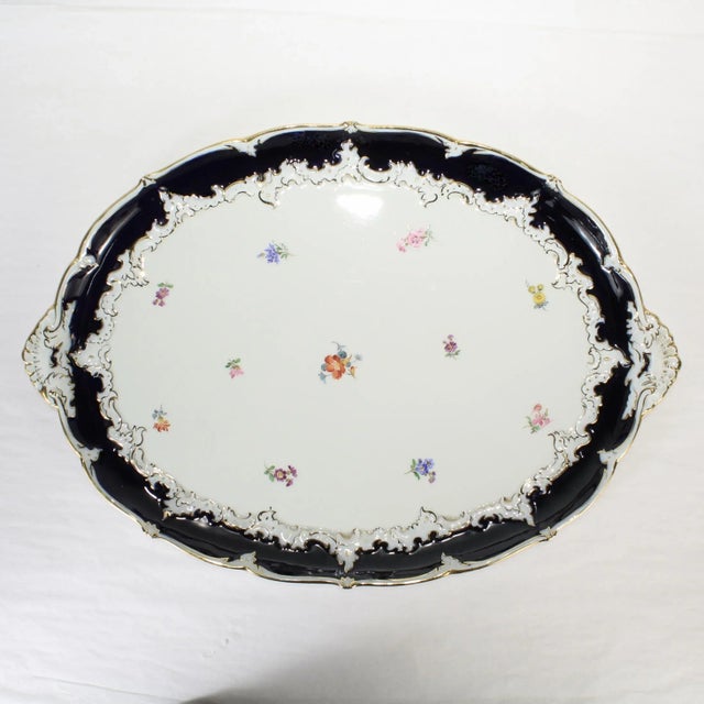 A fine antique porcelain tea tray or serving platter. By Meissen. With a scalloped rim and a rich cobalt blue border....
