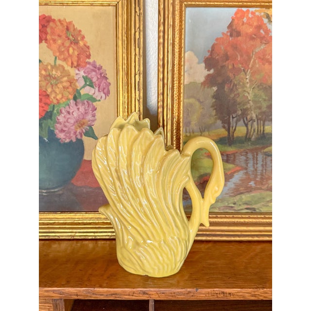 Charming chartreuse stoneware swan vase. This piece is in the style of McCoy pottery or Shawnee Pottery, with a lovely...