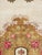 A vintage European continental carpet from the mid-20th century. A large golden brown medallion of roses populates the...