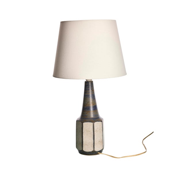 Add a touch of Scandinavian sophistication to your space with this unique stoneware lamp by Marianne Starck. The lamp...