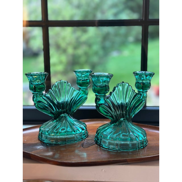 A striking pair of authentic 1930s Depression glass two-light candlestick holders by the Jeannette Glass Company in the...