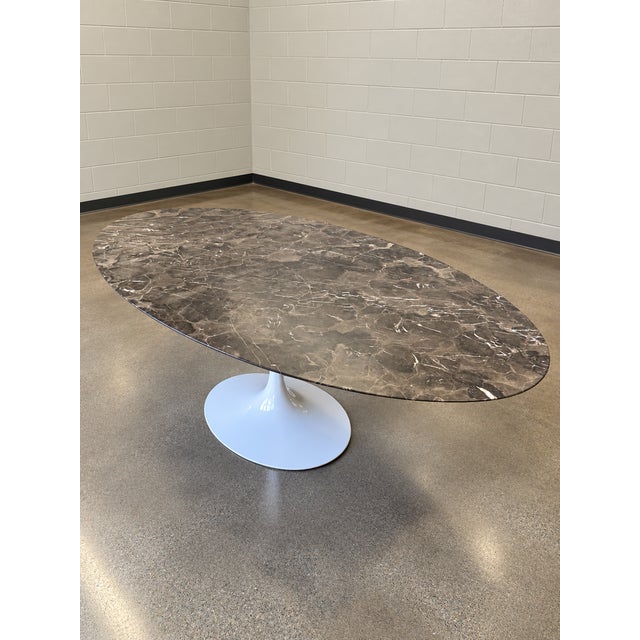 Gorgeous oval Tulip Table by Eero Saarinen for Knoll. The 84” table is topped in satin-coated Espresso marble and sits...