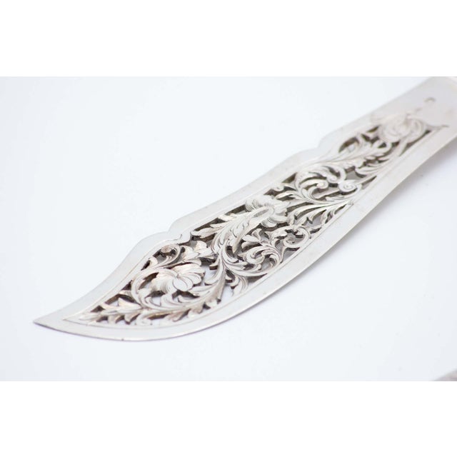 Silver Fish Knife and Fork with Cutouts, Set of 2, in Very Good conditions. Designed before 1890 This piece has an...