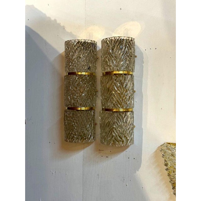 Elegant pair of Modern Murano wave glass and brass barrel sconces. Makes a beautiful statement! 18h x 6w x 5d