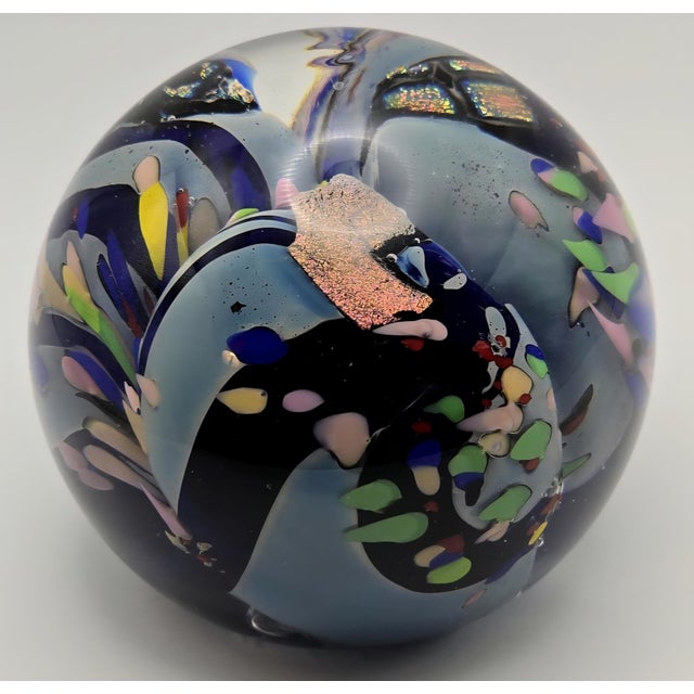 Glass paperweight, created by Rollin Karg, a well-known glass artist from Kansas. This piece features an abstract design...