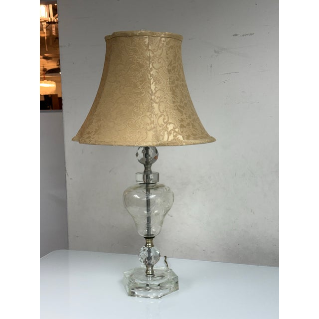 Design Plus Gallery presents a Vintage Cut Glass Table Lamp. The cut glass table lamp has an etched clear glass body,...