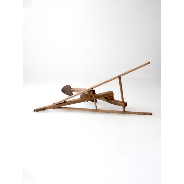 Late 19th-century horse-drawn walking cultivator with a wood frame, long flared handles, iron hardware, and broad...