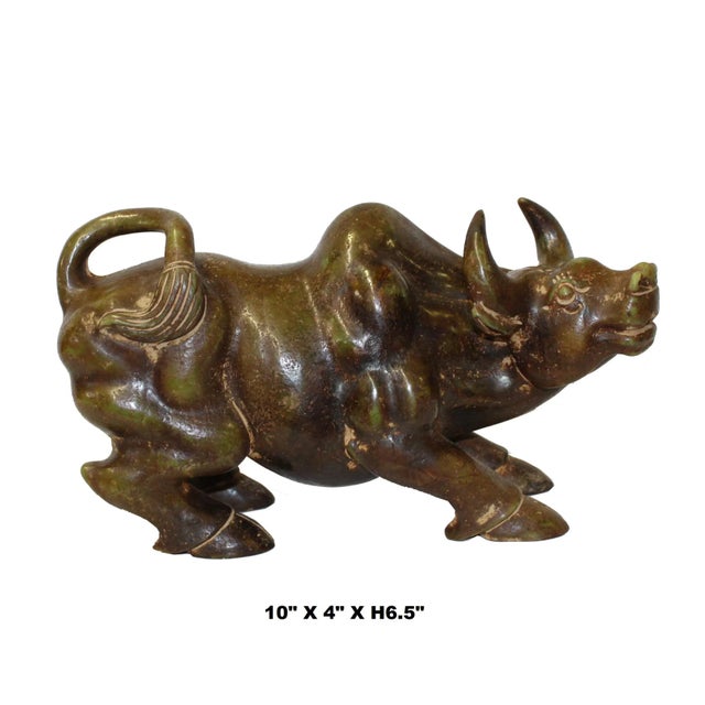 This Ox Cow figure is carved from a dark green brown mix color stone. There is a variation of color around the body....