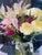 This artwork features a vibrant bouquet of flowers, rendered in expressive brushstrokes that convey both movement and...