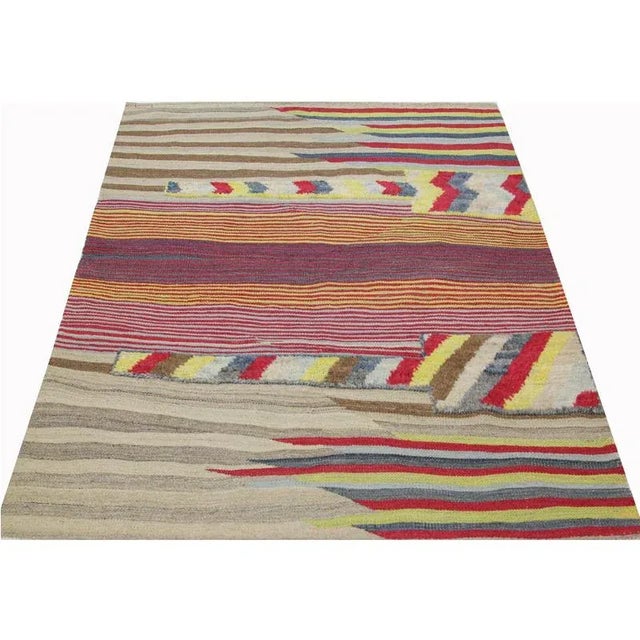 This bewitchingly beautiful example of a tribal Kilim area rug features a contemporary pop of electrifying bright colors...
