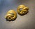 A harmonious pairing defined by their shared matte gold finish—a soft, brushed texture popularized during Hollywood’s...