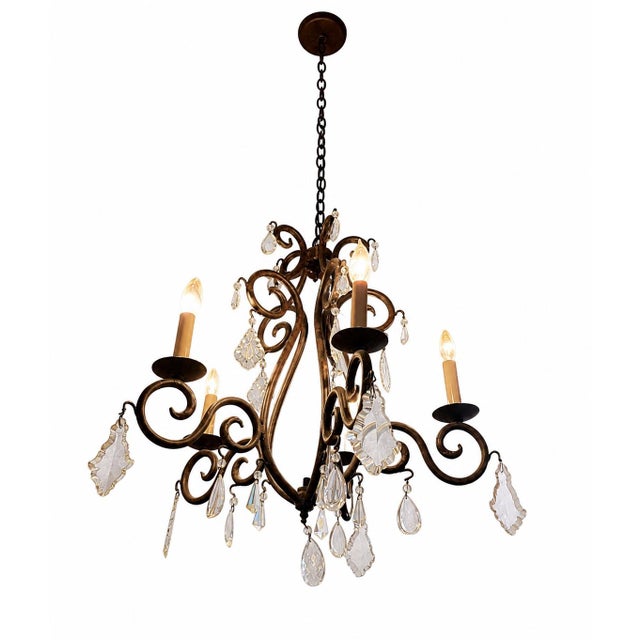 Elegant vintage crystal chandelier featuring candle-style lighting and ornate detailing. The fixture gives off a warm,...