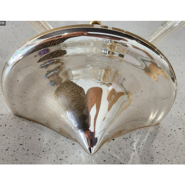 Murano glass wall sconce in the Luna line with a gold dust (aventurine) finish, two arms, and matching glass bobèches (the...