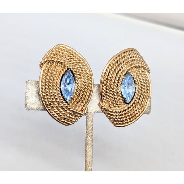 1950s goldtone ribbed pointed oval shape with single marquise faux-aquamarine clip earrings. Marked "NAPIER PAT. PEND."...
