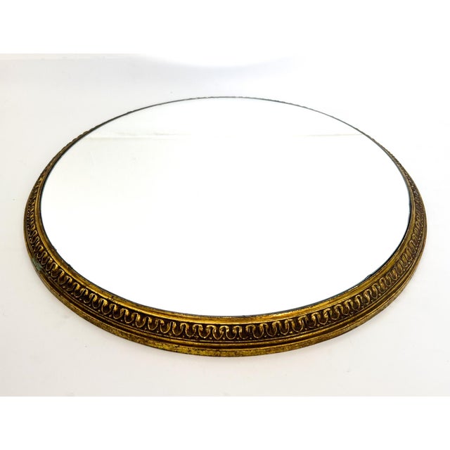 Large and eye-catching vintage gilt metal plateau featuring a newly added mirrored surface. The frame, originally part of...