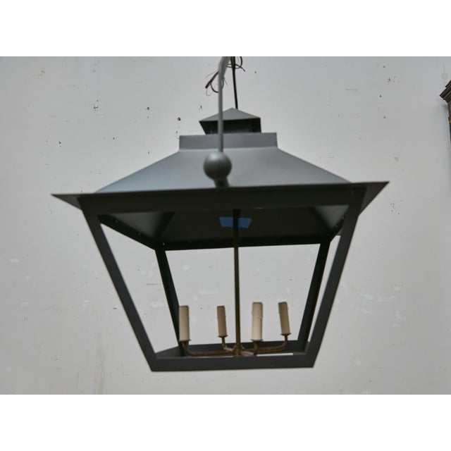 A striking pair of large-scale iron lanterns, newly made and designed with clean, architectural lines. Each lantern...