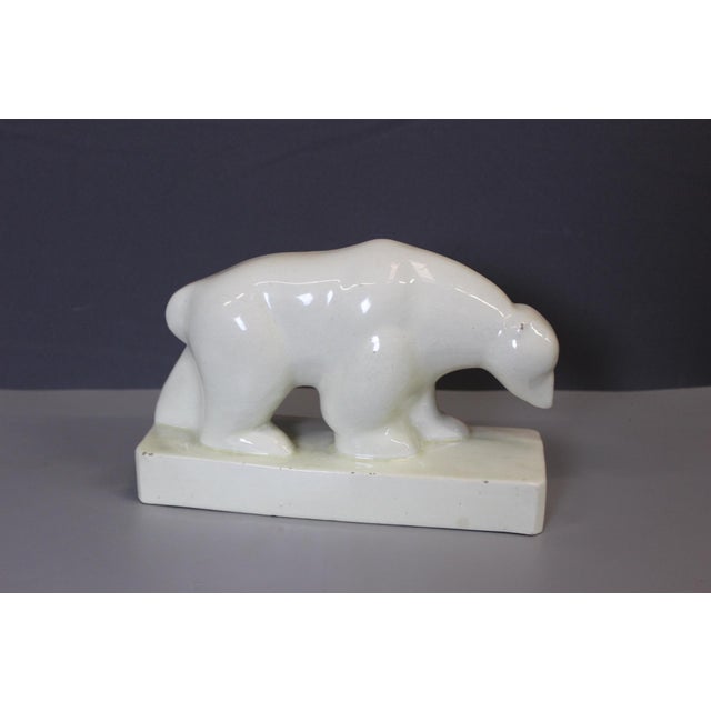 Art Deco crackle-glazed earthenware polar bear produced by Saint Clément and signed Geo Condé in relief on the base, circa...