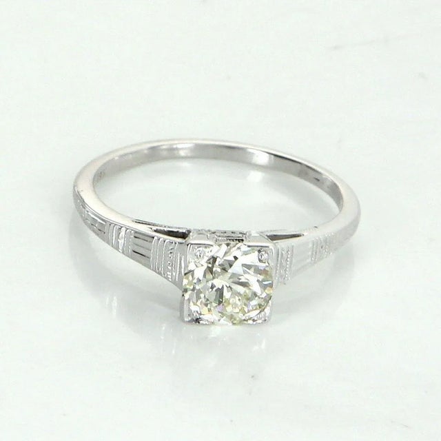 Art Deco era engagement ring (circa 1920s to 1930s), crafted in 18 karat white gold. Centrally mounted estimated 0.85...
