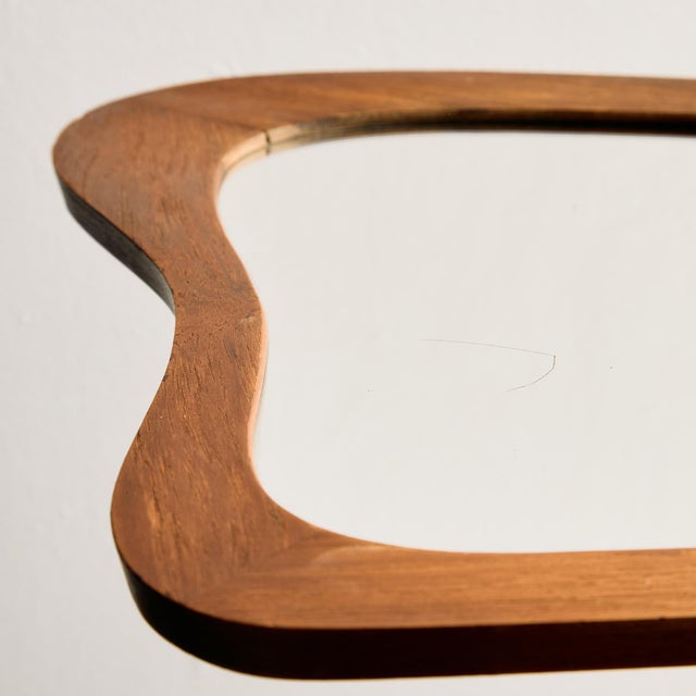 Organic shaped teak framed mirror from the 1960s. with some surface scratches, wear on the mirror parts.