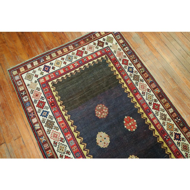 An eclectic Talish runner with a striated blue and navy ground surrounded by a colorful geometric border. The quality is...