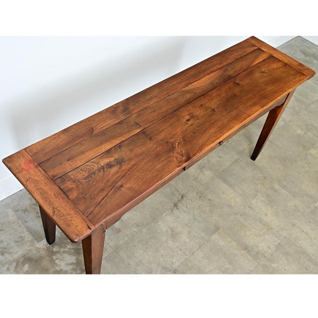 A 19th-century French walnut server or console table with a simplistic design with a beautifully patinated surface. The...