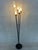 Original 1950s floor lamp with black metal structure and brass details. 5 tubes of textured glass. 5 x E14 sockets. Foot...