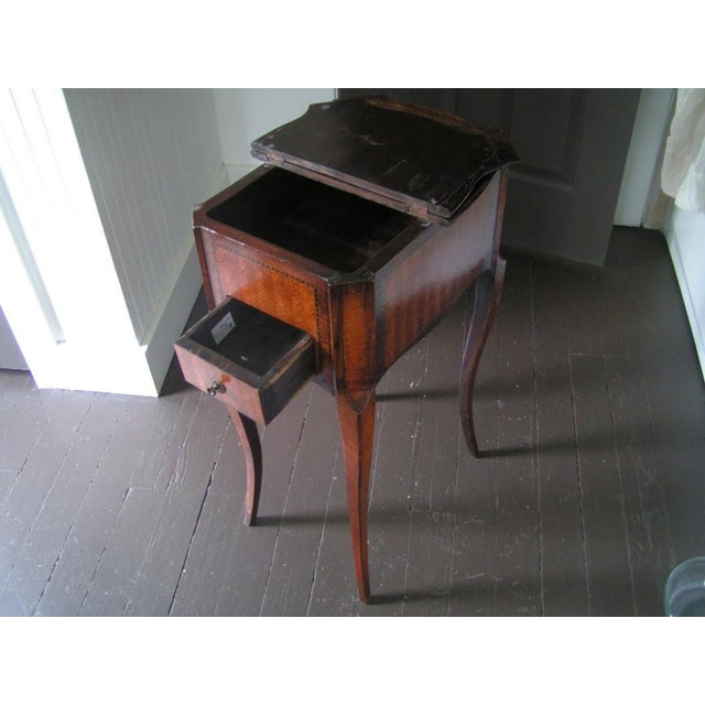 Late 19th century marquetry side table with fine herringbone motif. One-drawer with a double-sided hinged top that opens...