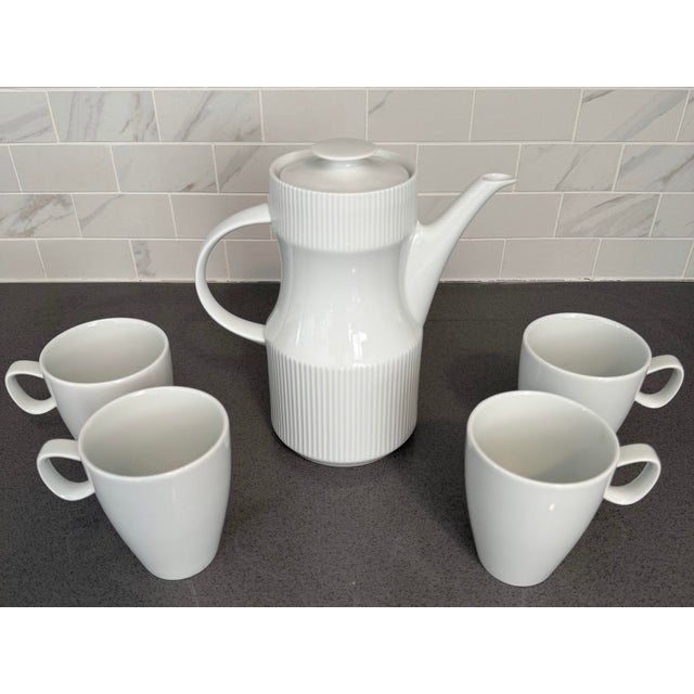 This vintage tea /coffee / hot chocolate set has the most wonderful minimalist MCM design. The white porcelain pot with...