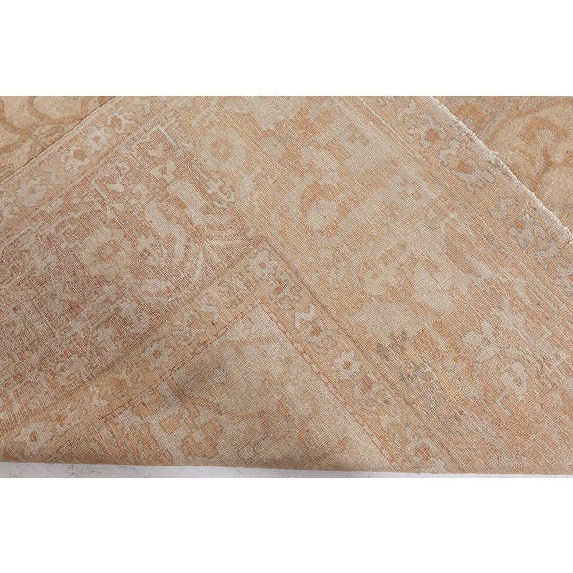 An early century Indian Amritsar antique rug, the abrashed sand field with a whimsical allover apricot angular flowering...