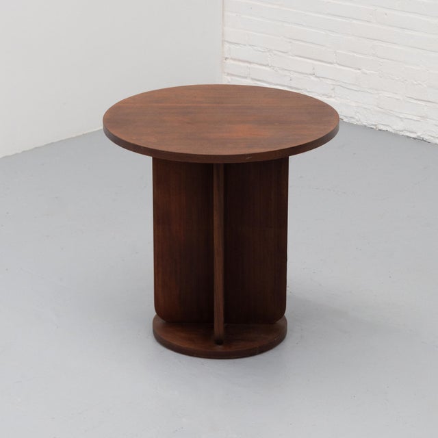 Round Dutch Art Deco side table dating from around the 1930s, executed in dark-stained wood with a warm reddish-brown...