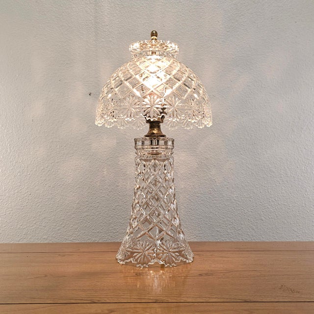 A mid-century cut crystal glass boudoir table lamp dating to circa the 1950s–1960s, combining a substantial pedestal base...
