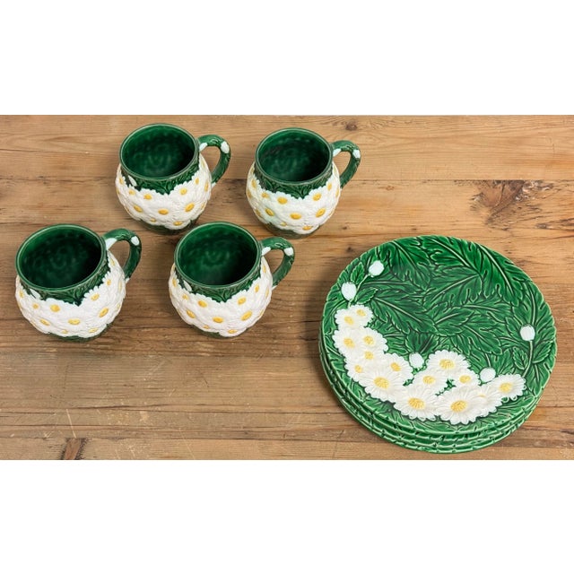 Charming vintage mug and dessert plate set featuring white daisy pattern with vibrant green leaf background. Four mugs and...