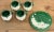 Charming vintage mug and dessert plate set featuring white daisy pattern with vibrant green leaf background. Four mugs and...