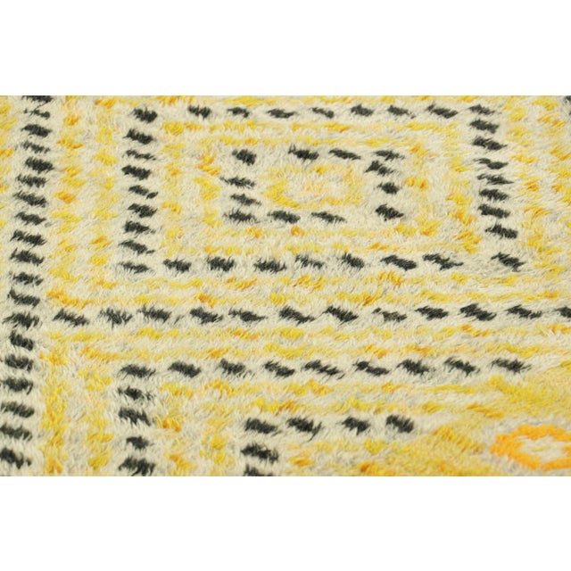 Hand-knotted in lush, high-pile wool in Sweden circa 1960-1970, this 4x7 vintage Swedish Rya rug is a bold new addition to...
